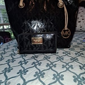 Black and Gold Michael Kors purse and wallet set.